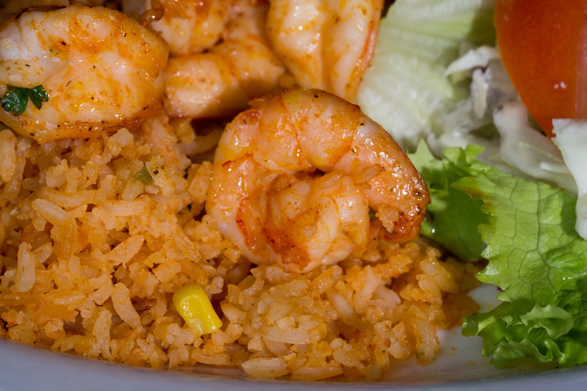 Seasoned shrimp over Mexican rice with a fresh green salad
