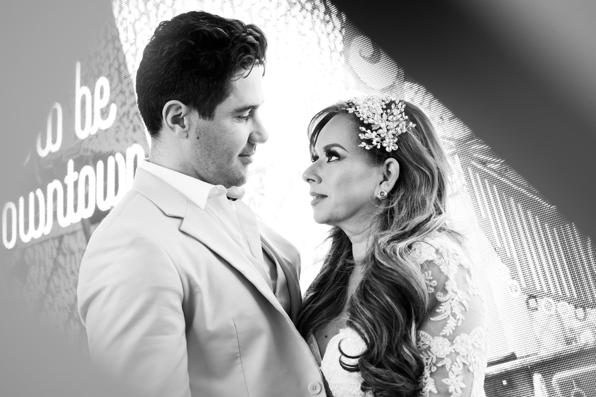Black-and-white close portrait of a bride and groom looking into each other’s eyes