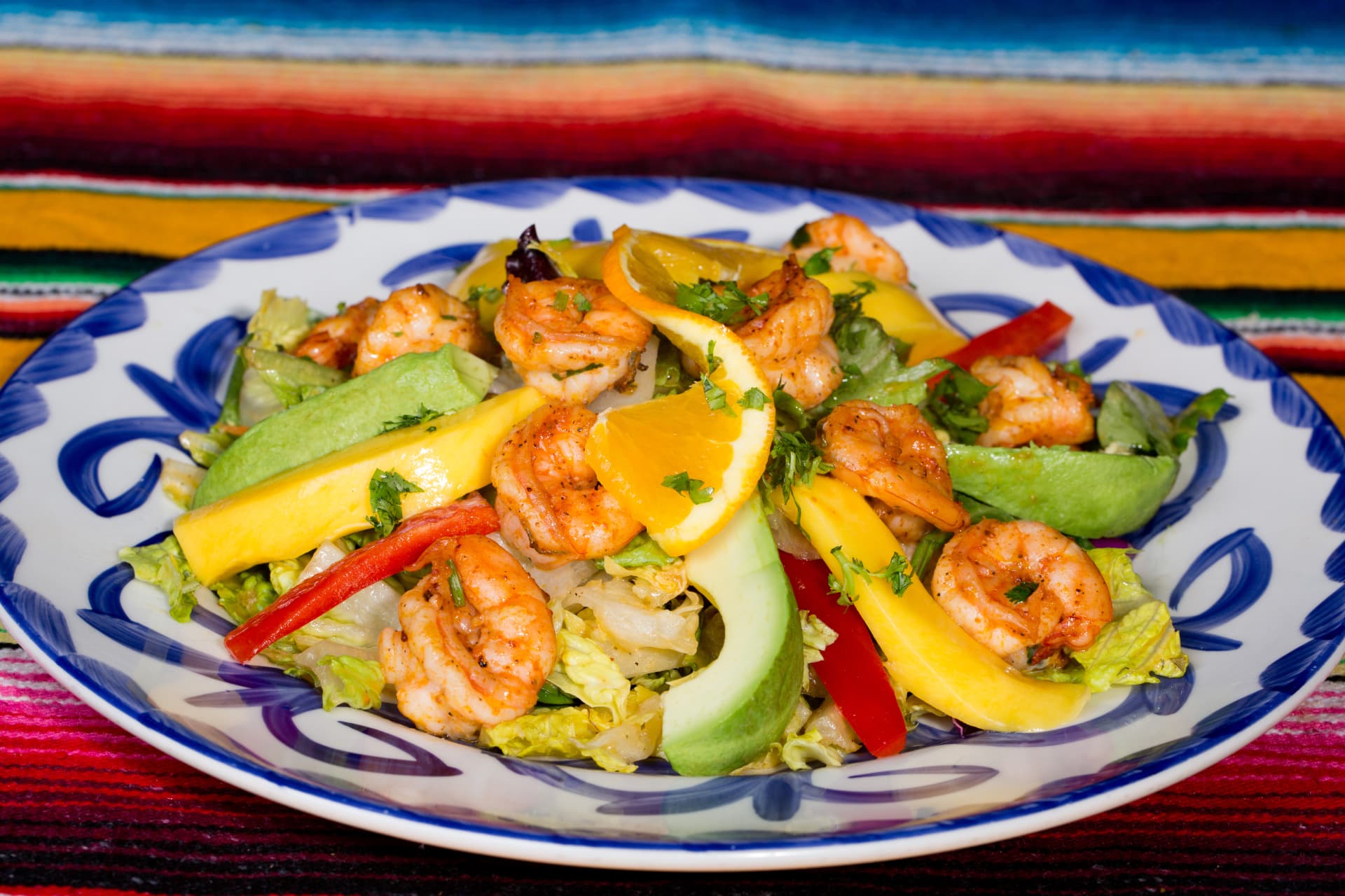Grilled shrimp salad with avocado, mango, peppers, orange, and cilantro