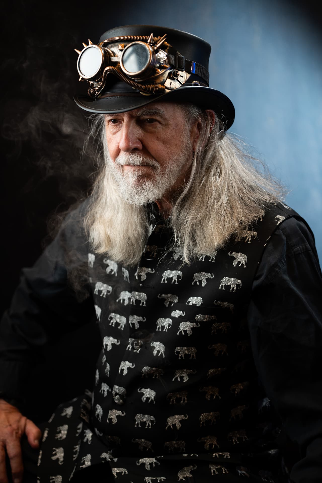 Character portrait of a man wearing a steampunk hat and patterned vest